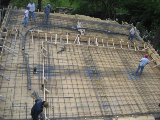 Construction workers preparing rebar for concrete slab